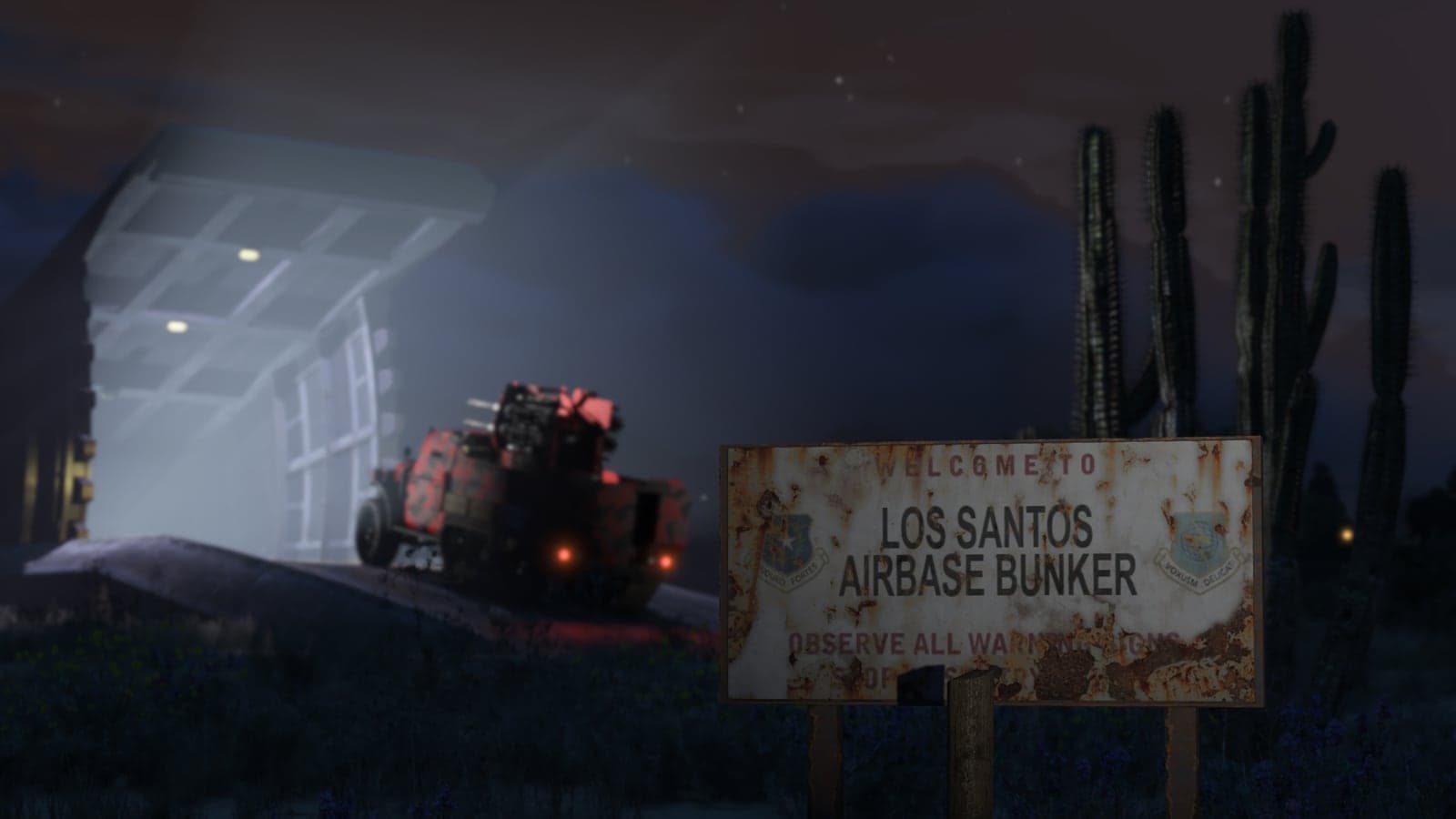 A vehicle entering the Los Santos Airbase Bunker at night in GTA Online