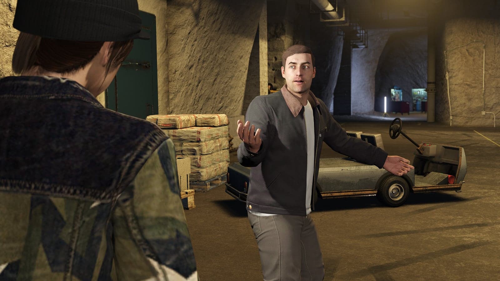 Agent 14 speaking to a player beside equipment inside a GTA Online Bunker