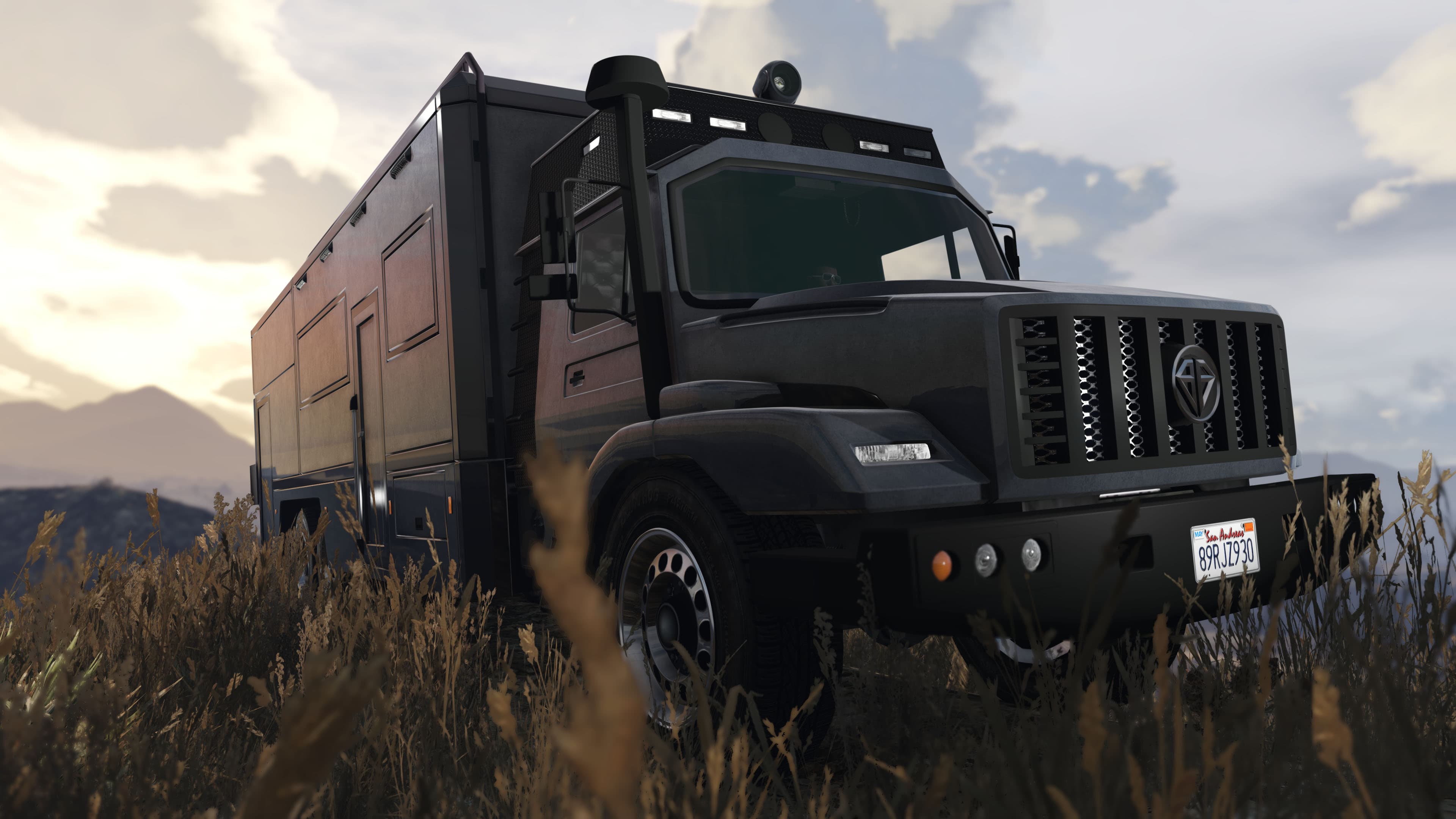 Benefactor Terrorbyte parked in grassy terrain near mountains in GTA Online